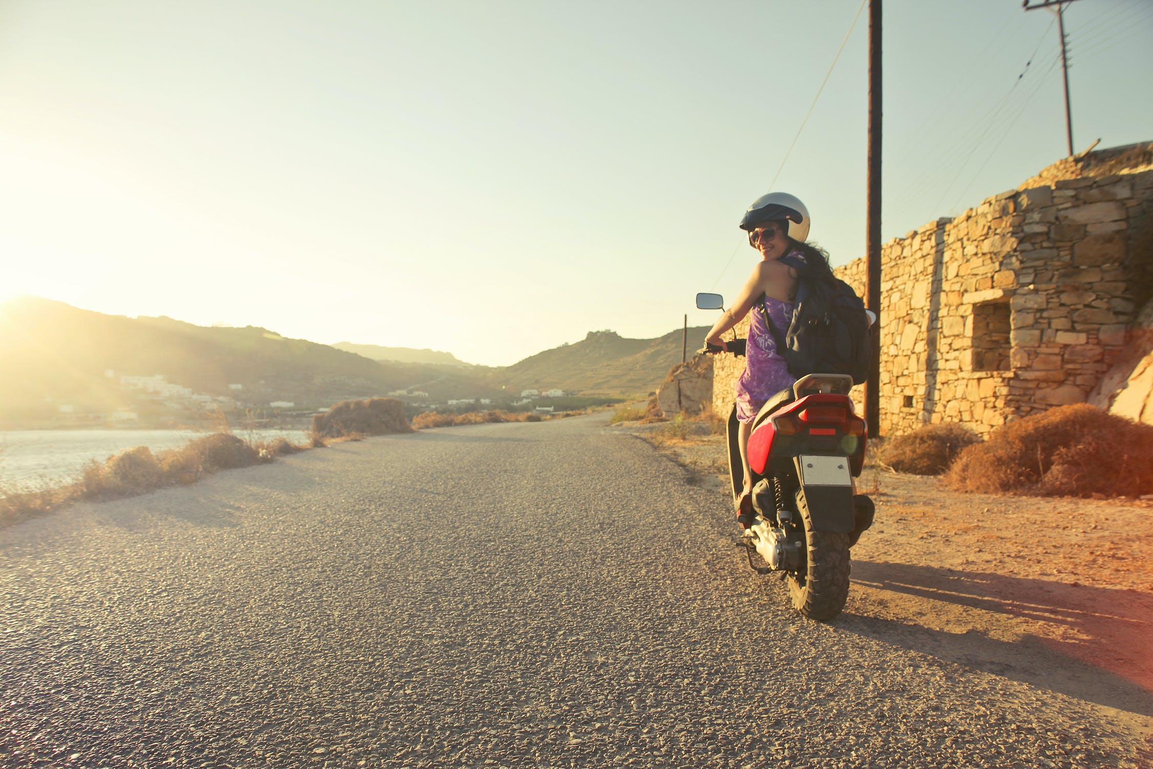 Can you listen to music on headphones while riding a motorcycle?